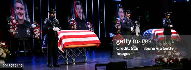 The caskets representing the fallen are placed in the sanctuary at Grace Church during the memorial service there for Burnsville, Minn. Police...