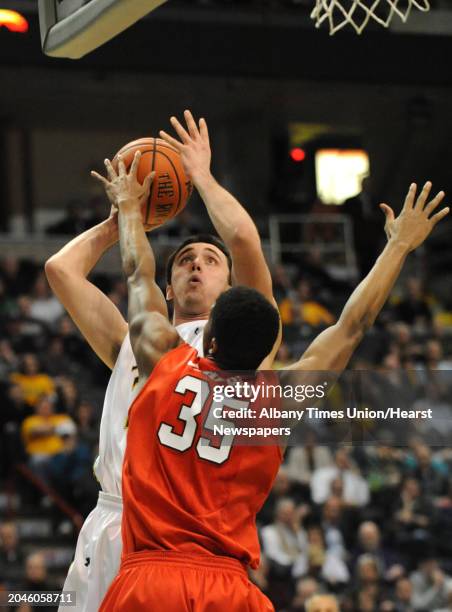 Siena's Brett Bisping is guarded by Fairfield's Coleman Johnson during a basketball game at the Times Union Center Monday, Feb. 10, 2014 in Albany,...