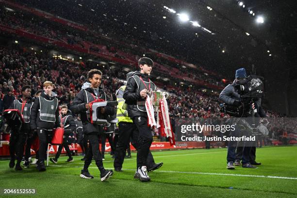 Ballboy carries the Carabao Cup around the pitch prior to the Emirates FA Cup Fifth Round match between Liverpool and Southampton at Anfield on...