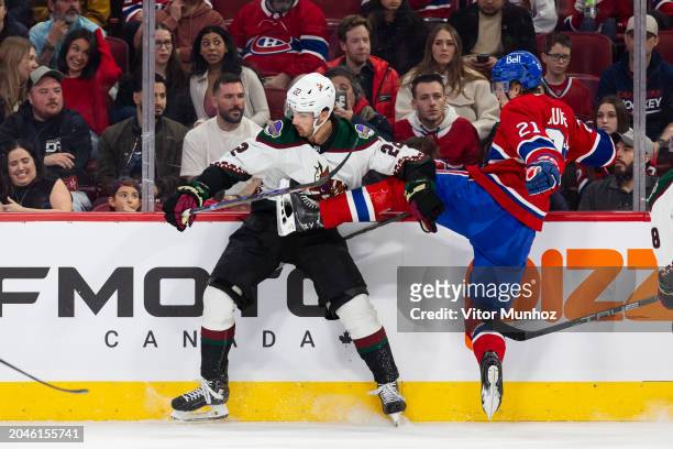 Jack McBain of the Arizona Coyotes hits Kaiden Guhle of the Montreal Canadiens during the first period of the NHL regular season game at the Bell...