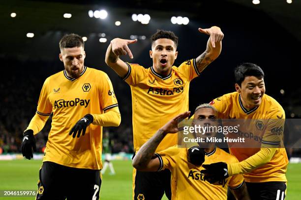 Mario Lemina of Wolverhampton Wanderers celebrates scoring his team's first goal with teammates Matt Doherty, Joao Gomes and Hwang Hee-Chan during...