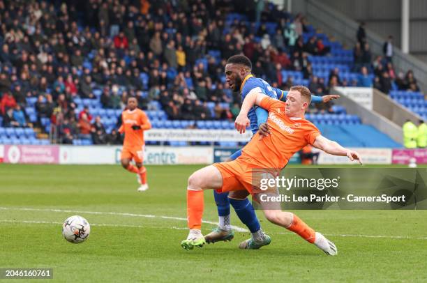 Shrewsbury Town's Cheyenne Dunkley holds off the challenge from Blackpool's Shayne Lavery during the Sky Bet League One match between Shrewsbury Town...