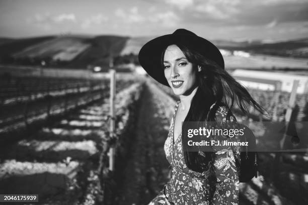 woman with hat walking through vineyard, in black and white - black and white instant print stock pictures, royalty-free photos & images