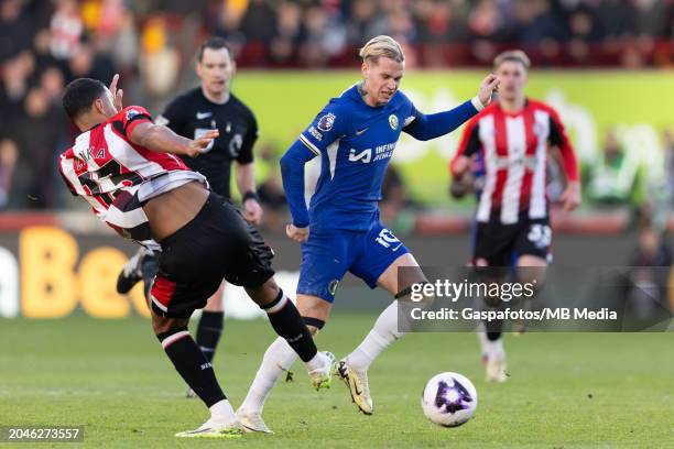 Mykhaylo Mudryk of Chelsea is challenged by Mathias Zanka Jorgensen of Brentford during the Premier League match between Brentford FC and Chelsea FC...