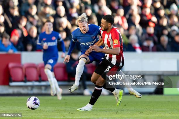Mykhaylo Mudryk of Chelsea is tackled by Mathias Zanka Jorgensen of Brentford during the Premier League match between Brentford FC and Chelsea FC at...