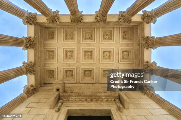 unusual angle of the majestic colonnade of a roman temple known as "maison carrée" in nîmes, occitanie, france - nimes stock pictures, royalty-free photos & images