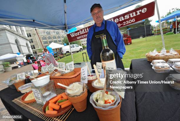 Vendor Jim Flynn of Worlding's Pleasure stands behind his stand at Connect Farmers' Market at SUNY Plaza Thursday June 12, 2014 in Albany, N.Y.