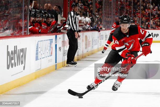 Colin Miller of the New Jersey Devils controls the puck during the first period against the Montreal Canadiens at Prudential Center on February 24,...