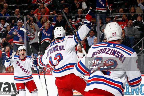 Erik Gustafsson reacts with Alexis Lafreniere of the New York Rangers after Lafreniere's goal scored during the first period against the New Jersey...