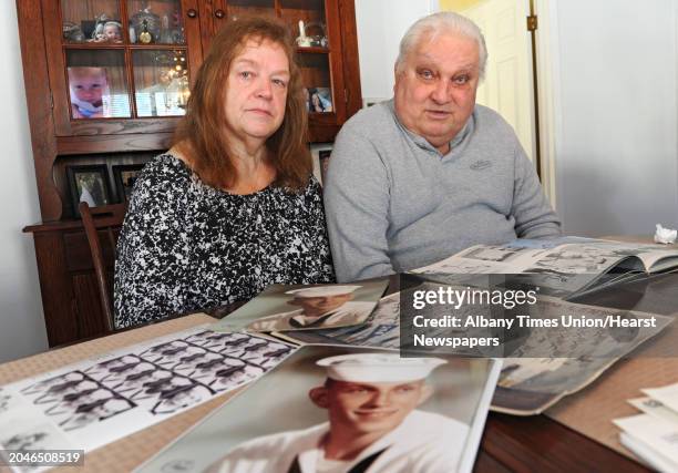 Joanne and Peter Sajta look at photos and books from when Peter served in the Navy in Vietnam at their home on Thursday, Jan. 15, 2015 in Hagaman,...