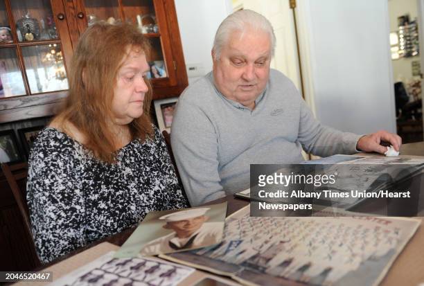 Joanne and Peter Sajta look at photos and books from when Peter served in the Navy in Vietnam at their home on Thursday, Jan. 15, 2015 in Hagaman,...