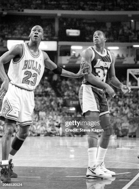 View of American basketball player Michael Jordan , of the Chicago Bulls, and Magic Johnson , of the Los Angeles Lakers, on the court during the...