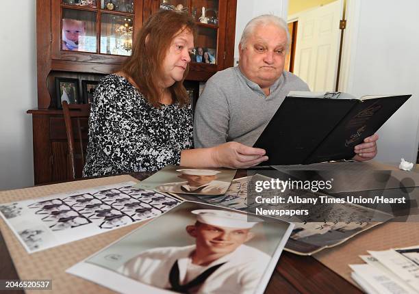 Joanne and Peter Sajta look at photos and books from when Peter served in the Navy in Vietnam at their home on Thursday, Jan. 15, 2015 in Hagaman,...