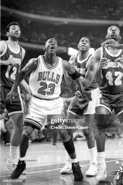 View of American basketball player Michael Jordan , of the Chicago Bulls, surrounded by from left, Serbian player Vlade Divac, Magic Johnson , and...