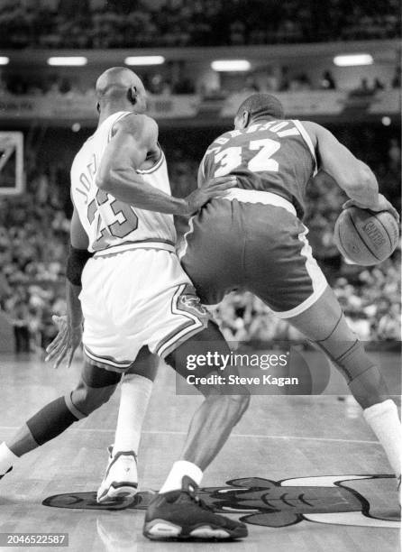 View of American basketball player Michael Jordan , of the Chicago Bulls, and Magic Johnson , of the Los Angeles Lakers, on the court during the...