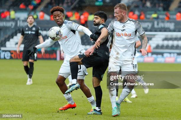 Dilan Markanday of Blackburn Rovers challenged by Jamal Lowe and Josh Tymon of Swansea City during the Sky Bet Championship match between Swansea...