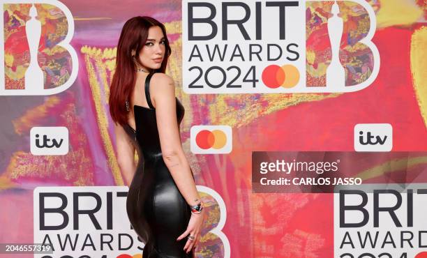 British singer-songwriter Dua Lipa poses on the red carpet upon arrival for the BRIT Awards 2024 in London on March 2, 2024. / RESTRICTED TO...