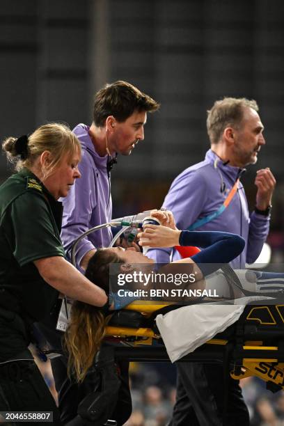 France's Margot Chevrier is evacuated on a stretcher after falling while competing in the Women's Pole Vault final during the Indoor World Athletics...