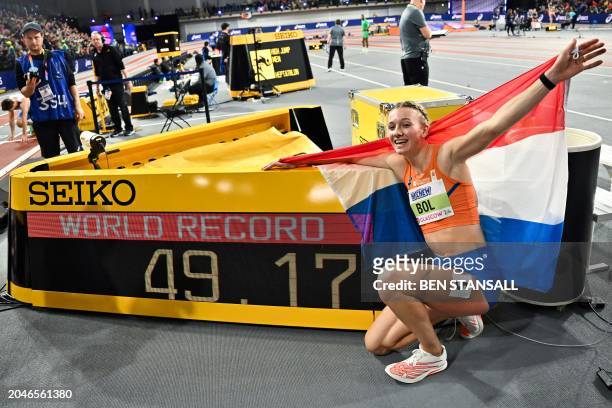 First-placed Netherlands' Femke Bol poses by the board after breaking the new world record in the Women's 400m final during the Indoor World...
