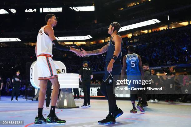 Victor Wembanyama of the San Antonio Spurs greets Paolo Banchero of the Orlando Magic during the Kia Skill Challenge as a part of State Farm All-Star...