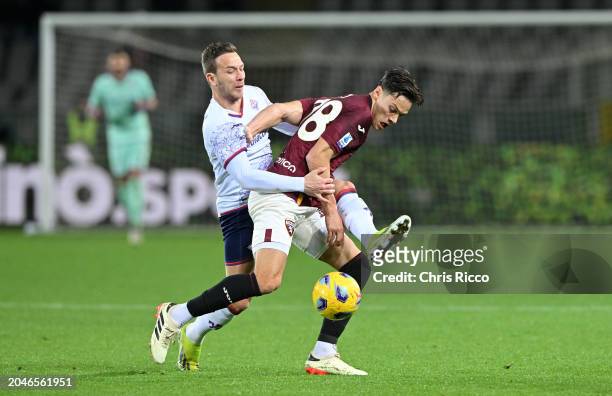 Samuele Ricci of Torino FC battles for the ball with Arthur Melo of ACF Fiorentina during the Serie A TIM match between Torino FC and ACF Fiorentina...