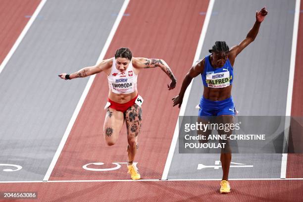 Second-placed Poland's Ewa Swoboda and first-placed Saint Lucia's Julien Alfred cross the finish line in the Women's 60m final during the Indoor...