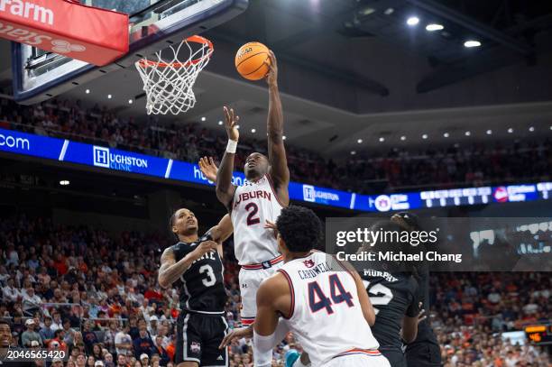 Jaylin Williams of the Auburn Tigers attempts a layup in front of Shakeel Moore of the Mississippi State Bulldogs and KeShawn Murphy of the...