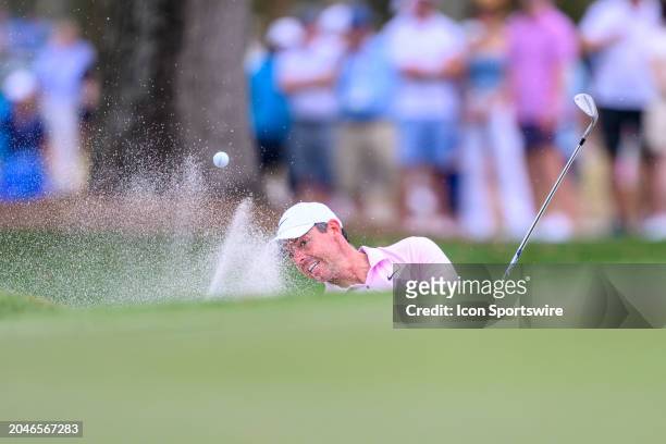 Rory McIlroy of Northern Ireland hits the ball out of a bunker at the tenth hole during the third round of Cognizant Classic in The Palm Beaches at...