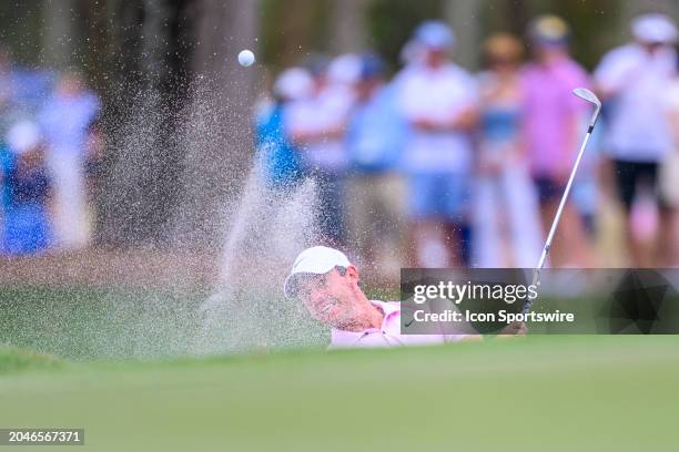 Rory McIlroy of Northern Ireland hits the ball out of a bunker at the tenth hole during the third round of Cognizant Classic in The Palm Beaches at...