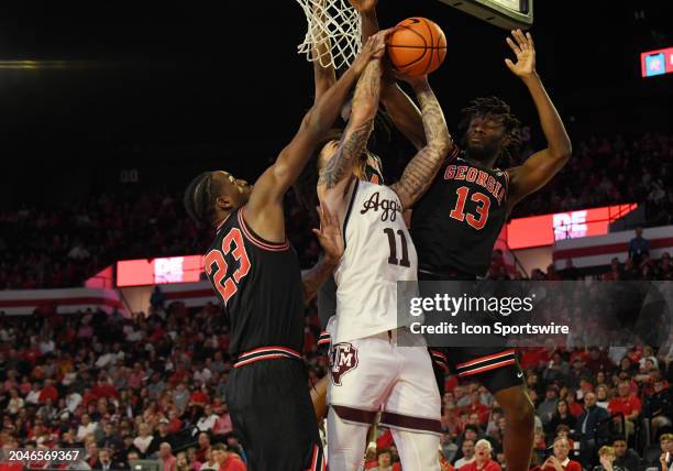 Georgia Bulldogs Forward Jalen DeLoach and Georgia Bulldogs Forward Dylan James defend as Texas A&M Aggies Forward Andersson Garcia shoots the ball...