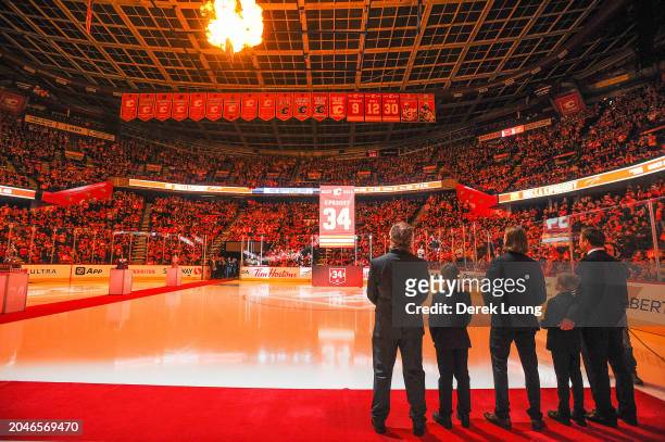 Miikka Kiprusoff of the Calgary Flames watches as his banner is raised during his jersey retirement ceremony prior to an NHL game against the...