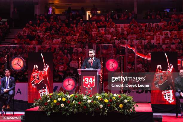 Miikka Kiprusoff of the Calgary Flames speaks to the crowd during his jersey retirement ceremony prior to an NHL game against the Pittsburgh Penguins...