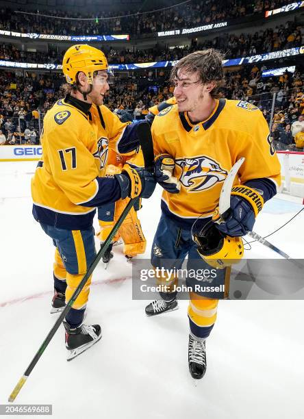 Mark Jankowski congratulates Cody Glass of the Nashville Predators on his hat trick after a 5-1 win against the Colorado Avalanche during an NHL game...