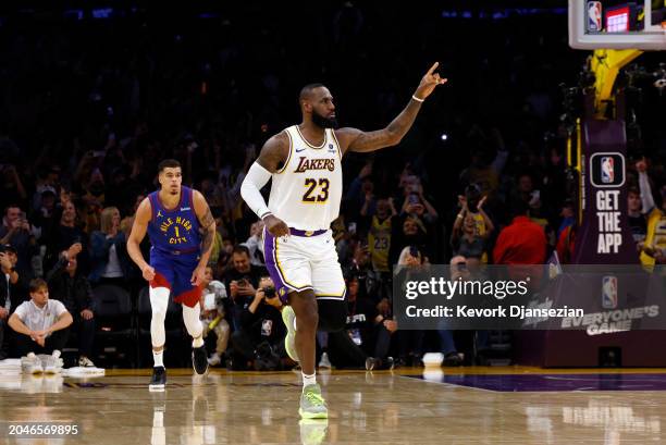 LeBron James of the Los Angeles Lakers reacts after scoring his 40,000th career point during the first half against the Michael Porter Jr. #1 of the...