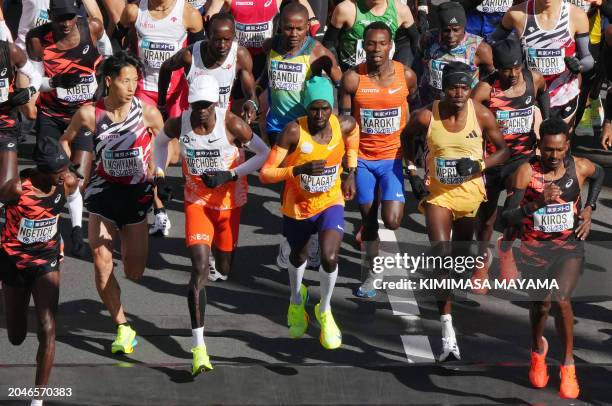 Kenya's Benson Kipruto , with compatriots Timothy Kiplagat , Vincent Kipkemoi Ngetich and Eliud Kipchoge set off from the start of the Tokyo Marathon...