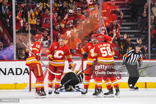 The Calgary Flames celebrate the goal of Yegor Sharangovich against the Pittsburgh Penguins during the second period of an NHL game at Scotiabank...