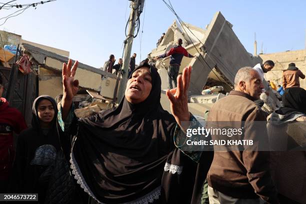 Palestinian woman reacts in front of the Abu Anza family home destroyed in an overnight Israeli air strike in Rafah in the southern Gaza Strip on...
