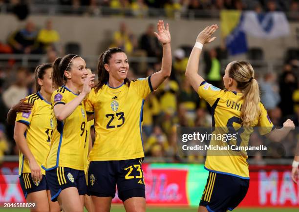 Pauline Hammarlund of Sweden celebrates scoring her team's fifth goal with teammates Kosovare Asllani and Matilda Vinberg during the UEFA Women's...