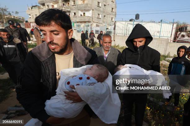 Graphic content / Men carry the bodies of twin babies Naeem and Wissam Abu Anza, killed in an overnight Israeli air strike, to be buried in Rafah in...