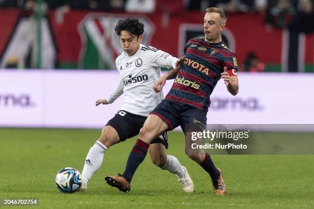 Ryoya Morishita and Kamil Grosicki are playing during the Legia Warsaw vs. Pogon Szczecin PKO Ekstraklasa match in Warsaw, Poland, on March 2, 2024.