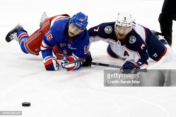 Vincent Trocheck of the New York Rangers and Sean Kuraly of the Columbus Blue Jackets battle for the puck after a face off during the first period at...