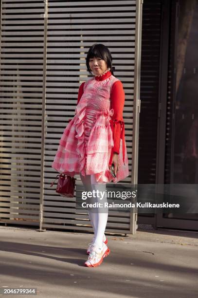 Susie Lau wears red top, white tights, white and red sneakers and white and red dress outside Courreges during the Womenswear Fall/Winter 2024/2025...