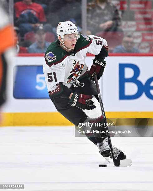 Troy Stecher of the Arizona Coyotes skates the puck during the third period against the Montreal Canadiens at the Bell Centre on February 27, 2024 in...