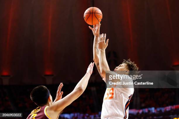 Coleman Hawkins of the Illinois Fighting Illini takes a shot over Dawson Garcia of the Minnesota Golden Gophers during the first half at State Farm...