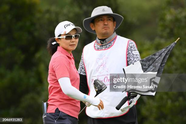 Ayako Uehara of Japan talks with her caddie on the 4th tee during the first round of Daikin Orchid Ladies Golf Tournament at Ryukyu Golf Club on...