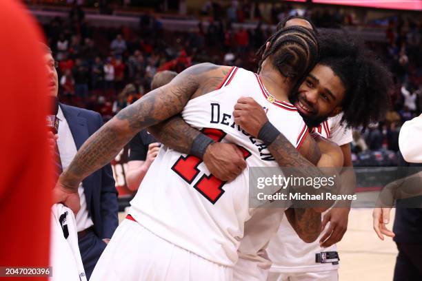 Coby White and DeMar DeRozan of the Chicago Bulls celebrate after defeating the Cleveland Cavaliers in double overtime at the United Center on...