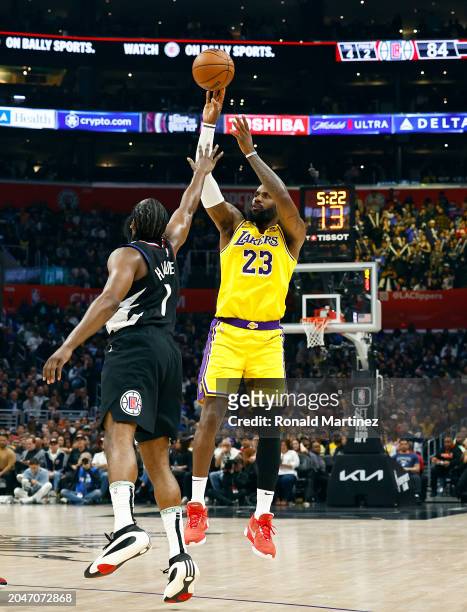 LeBron James of the Los Angeles Lakers takes a shot against Kawhi Leonard of the LA Clippers in the second half at Crypto.com Arena on February 28,...