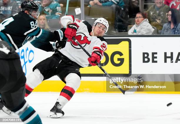 Timo Meier of the New Jersey Devils falling off balance shoots on goal against the San Jose Sharks during the first period of an NHL hockey game at...