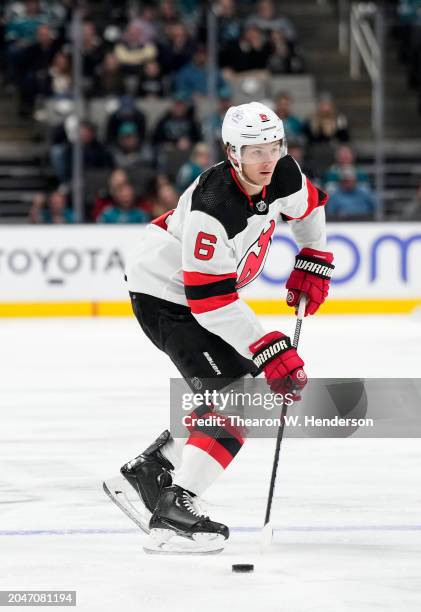 John Marino of the New Jersey Devils skates with the puck against the San Jose Sharks during the first period of an NHL hockey game at SAP Center on...