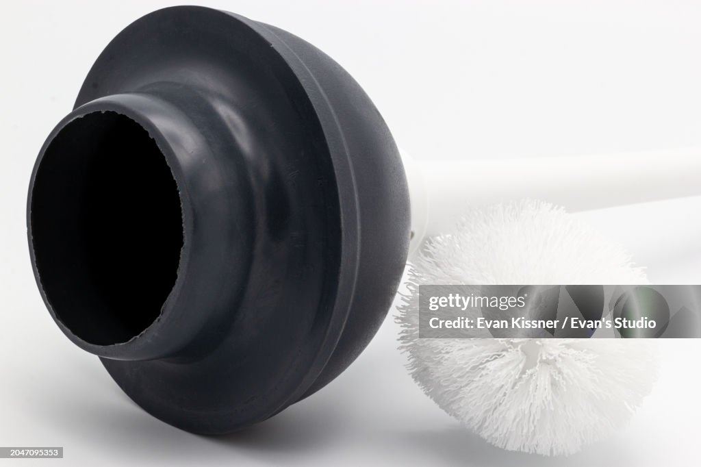 Black Toilet Bowl Plunger And a White Toilet Bowl Brush On A White Background II